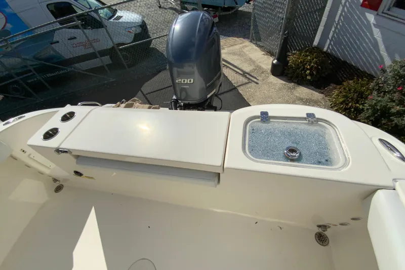 Slide: The Image of 2021 Cobia 220 Center Console boat with Yamaha 200 engine, featuring a livewell and storage area. - 20