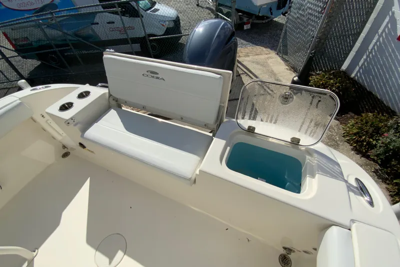 Slide: The Image of 2021 Cobia 220 Center Console boat interior with seating and storage compartment. - 21