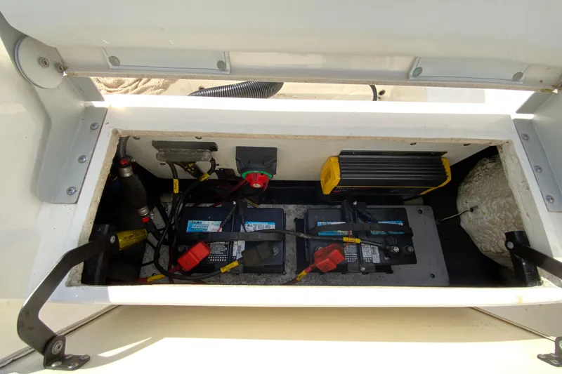 Slide: The Image of Battery compartment of a 2021 Cobia 220 Center Console boat, showing wiring and components. - 22
