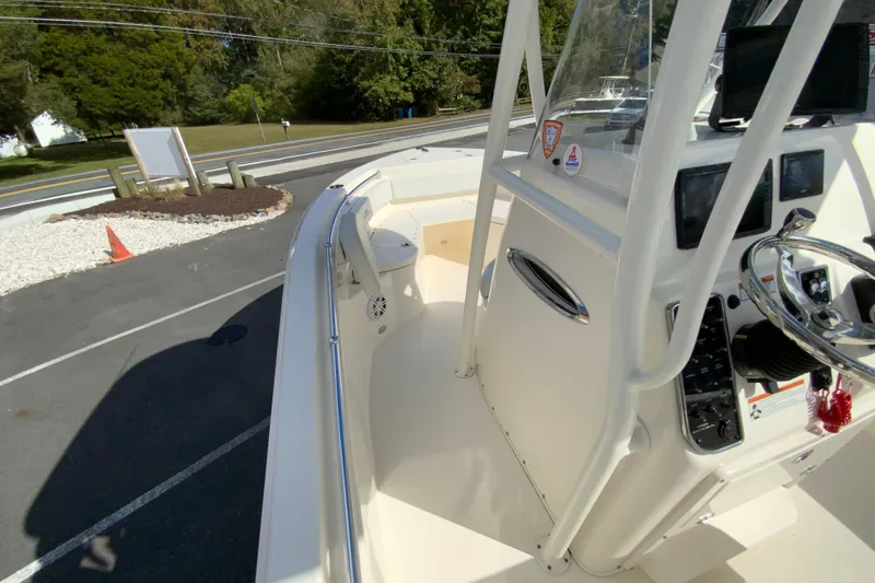 Slide: The Image of 2021 Cobia 220 Center Console boat with sleek design and modern controls. - 23
