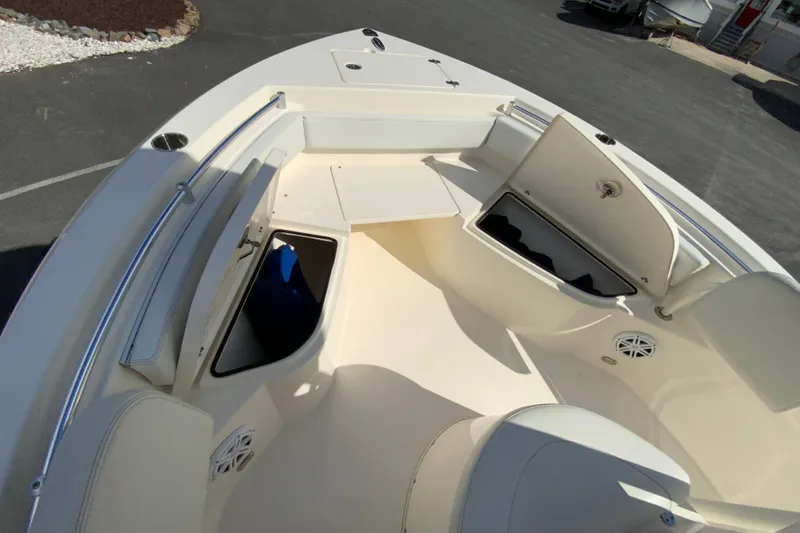 Slide: The Image of 2021 Cobia 220 Center Console boat interior with open storage compartments. - 25