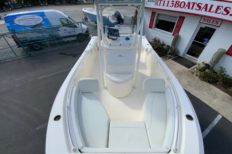 Slide: The Image of 2021 Cobia 220 Center Console boat at dealership, showcasing spacious seating and sleek design. - 30