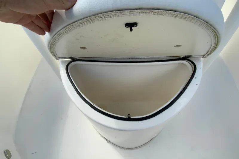 Slide: The Image of Open storage compartment on 2021 Cobia 220 Center Console boat. - 32