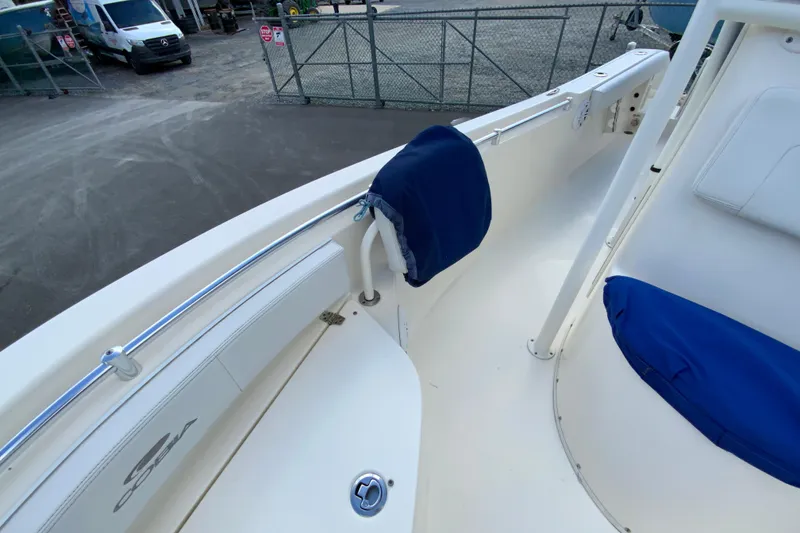 Slide: The Image of 2021 Cobia 220 Center Console boat interior with blue cushions and railing. - 39