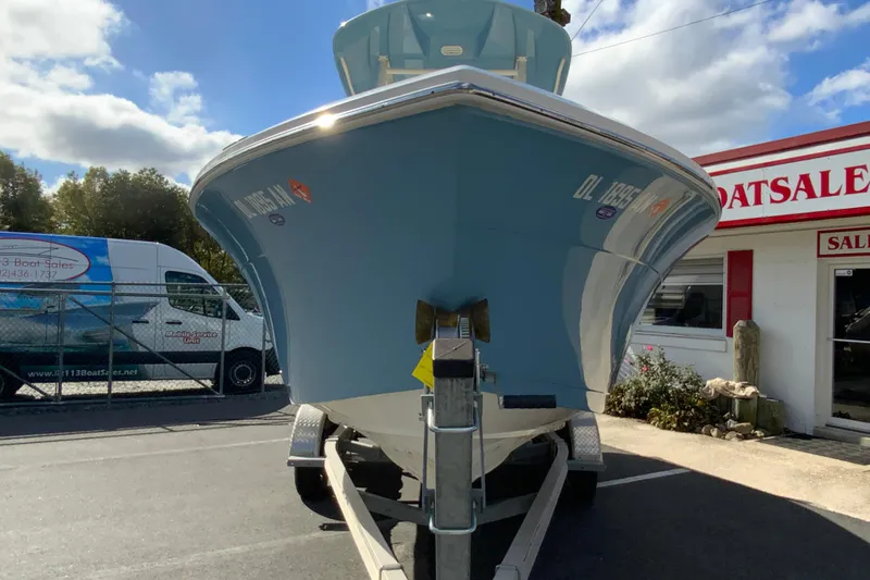 Slide: The Image of 2021 Cobia 220 Center Console boat on trailer at dealership. - 4