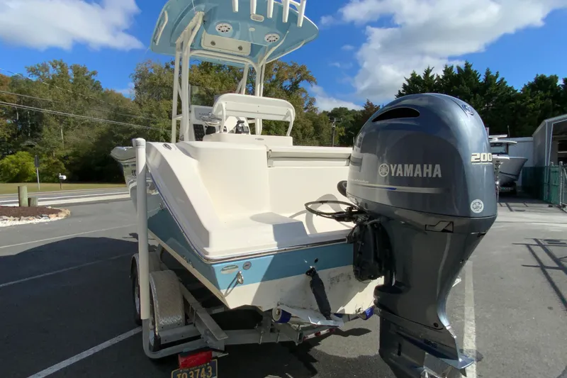 Slide: The Image of 2021 Cobia 220 Center Console boat with Yamaha 200 outboard motor on trailer. - 8