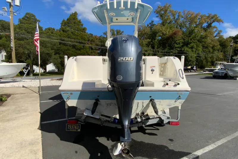 Slide: The Image of 2021 Cobia 220 Center Console boat with Yamaha 200 engine, parked outdoors. - 9