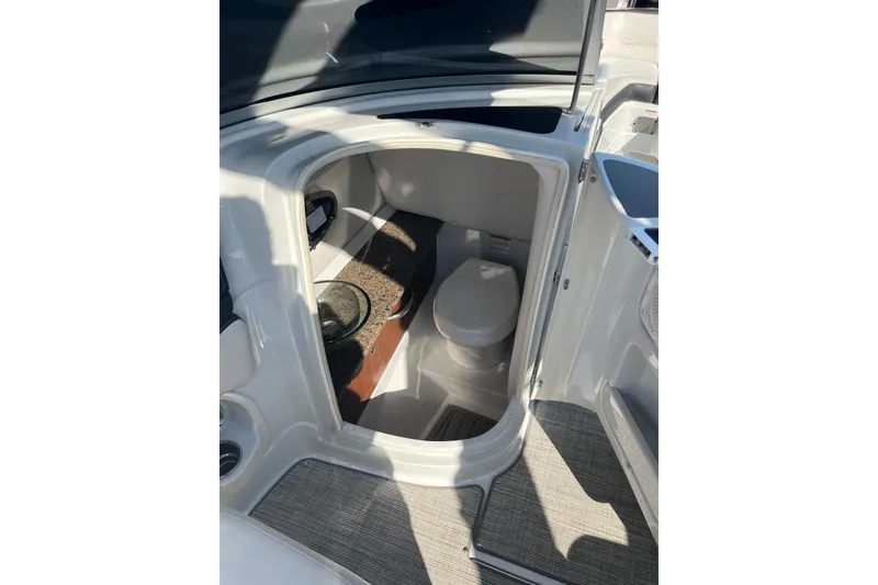 Slide: The Image of 2021 Crownline 290 SS boat interior with compact bathroom and modern amenities. - 16