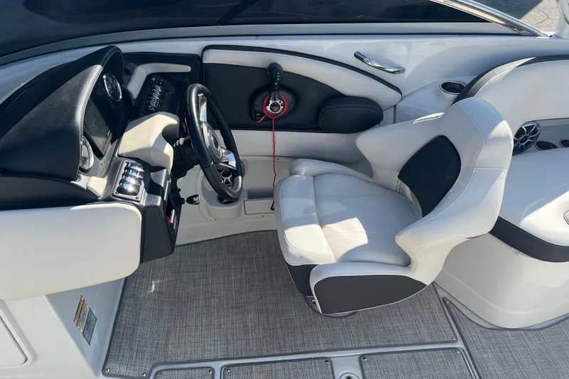 Slide: The Image of 2021 Crownline 290 SS boat interior with steering wheel and captain's seat. - 17