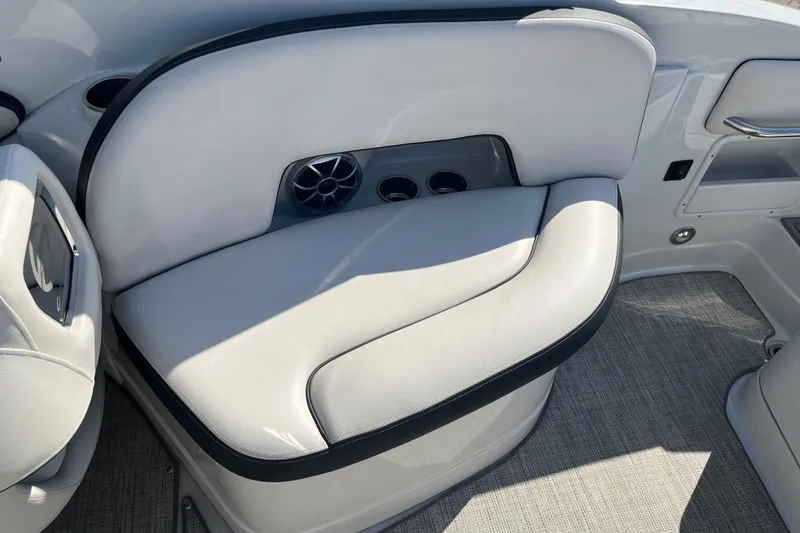 Slide: The Image of 2021 Crownline 290 SS boat interior with white cushioned seating and speaker. - 19