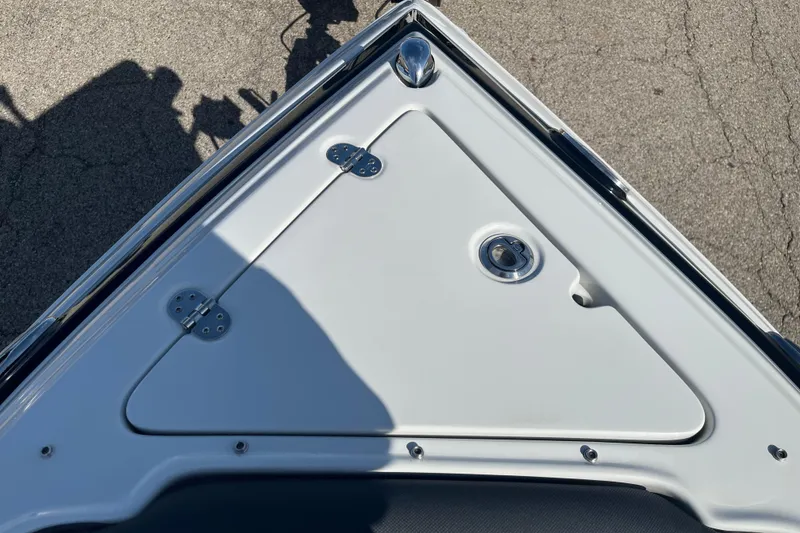 Slide: The Image of 2021 Crownline 290 SS boat bow with storage compartment and stainless steel fittings. - 2