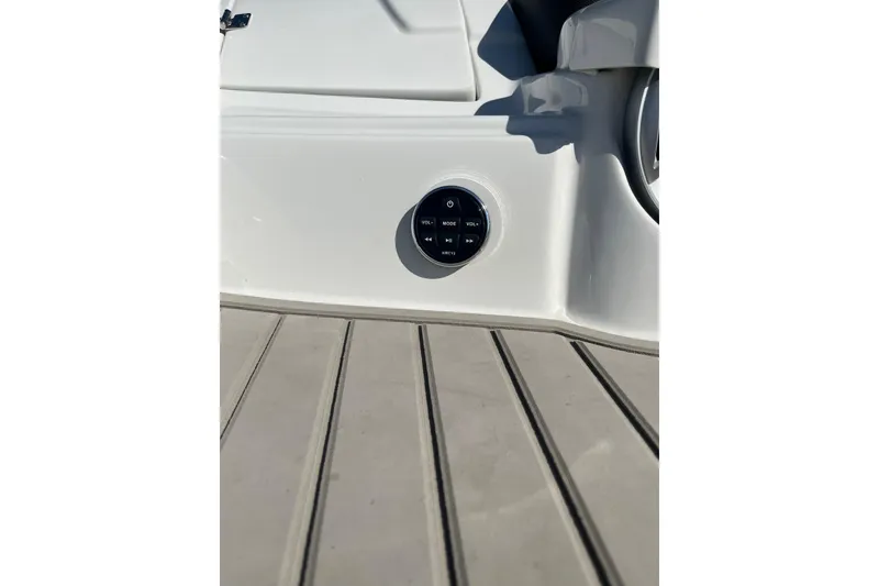 Slide: The Image of Crownline 290 SS 2021 boat control panel on deck, featuring audio controls. - 22