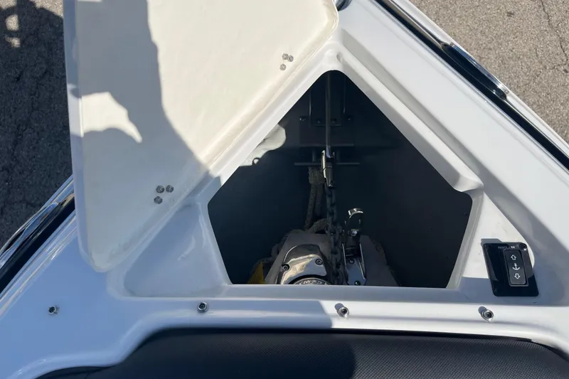 Slide: The Image of Open anchor compartment on 2021 Crownline 290 SS boat, showing anchor and control panel. - 3