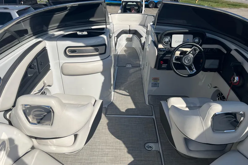Slide: The Image of 2021 Crownline 290 SS boat interior with modern dashboard and seating. - 4