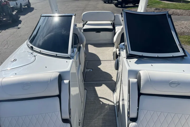 Slide: The Image of 2021 Crownline 290 SS boat interior with white seating and sleek design. - 8