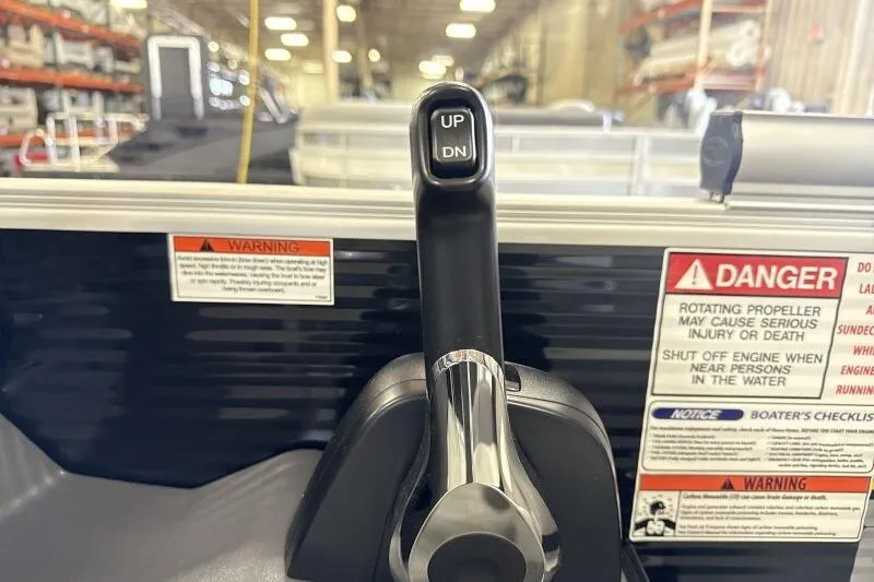 Slide: The Image of Throttle control lever on a 2026 Bennington 22 SSRSF boat with safety warnings. - 22