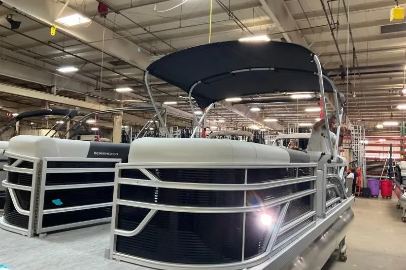 Slide: The Image of 2026 Bennington 22 SSRSF pontoon boat in a factory setting, showcasing sleek design. - 8