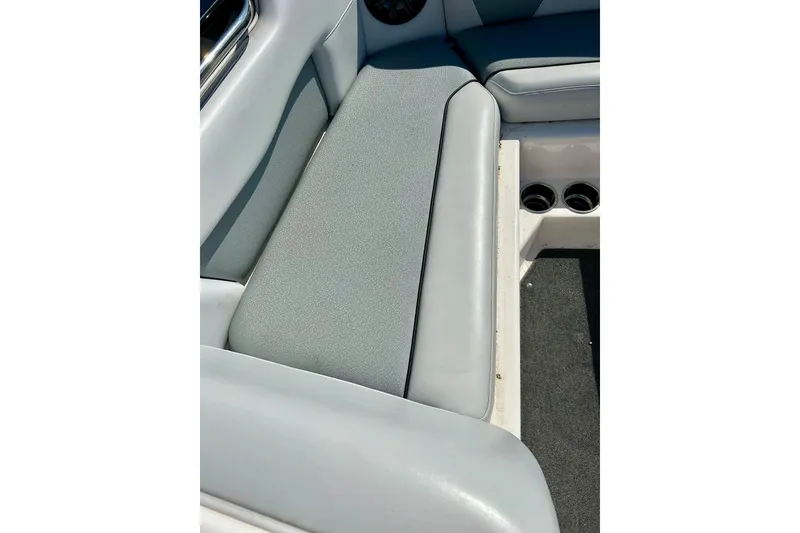 Slide: The Image of 2018 Moomba Helix boat interior with gray seating and cup holders. - 12
