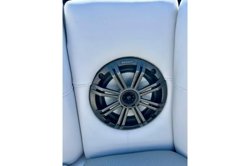 Slide: The Image of Kicker speaker on 2018 Moomba Helix boat's white interior upholstery. - 13