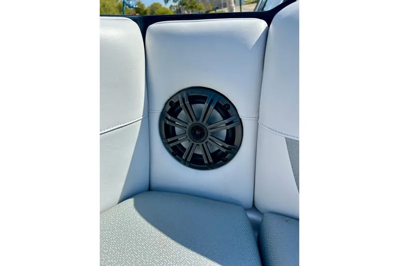 Slide: The Image of 2018 Moomba Helix boat interior with built-in speaker on white upholstery. - 14