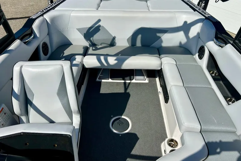 Slide: The Image of 2018 Moomba Helix boat interior with gray seating and carpeted floor. - 15