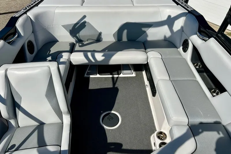 Slide: The Image of 2018 Moomba Helix boat interior with gray seating and cup holders. - 16