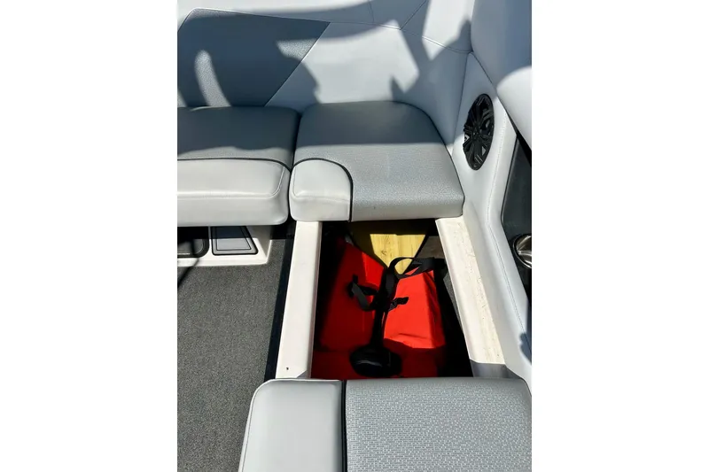 Slide: The Image of 2018 Moomba Helix boat interior with open storage compartment and speaker. - 19