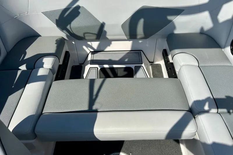 Slide: The Image of 2018 Moomba Helix boat interior with gray seating and storage compartments. - 22