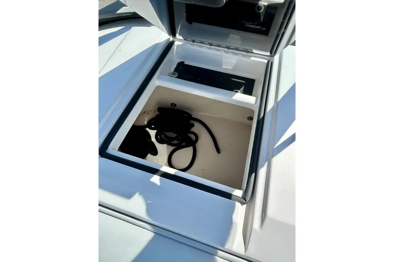Slide: The Image of Open storage compartment in 2018 Moomba Helix boat with coiled rope inside. - 25