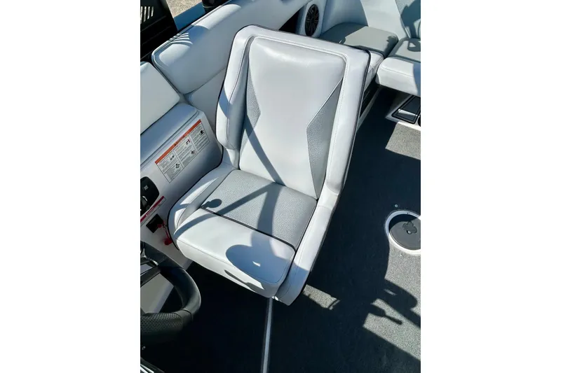 Slide: The Image of 2018 Moomba Helix boat interior with gray seating and control panel. - 30
