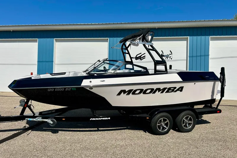 Slide: The Image of 2018 Moomba Helix boat on trailer, parked outside blue building. - 31