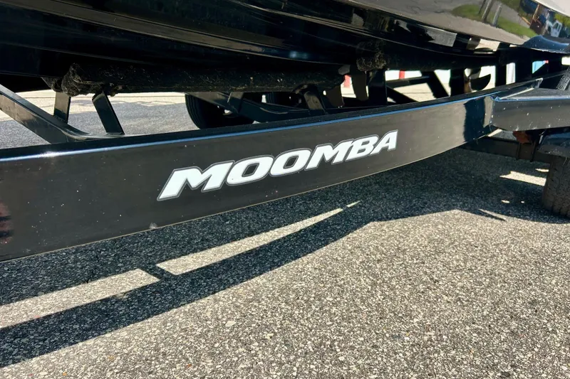 Slide: The Image of 2018 Moomba Helix boat trailer with logo, parked on asphalt. - 33