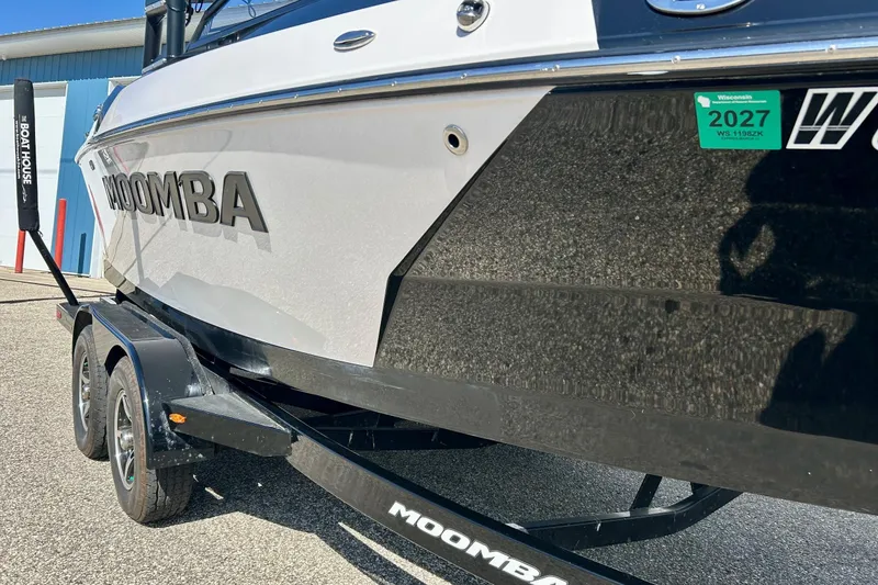 Slide: The Image of 2018 Moomba Helix boat on trailer, parked outdoors with visible registration sticker. - 7