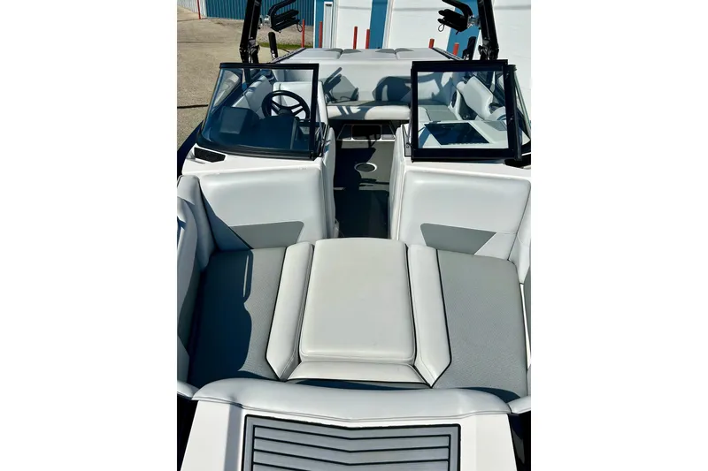 Slide: The Image of 2018 Moomba Helix boat interior with gray seating and open windshield. - 8