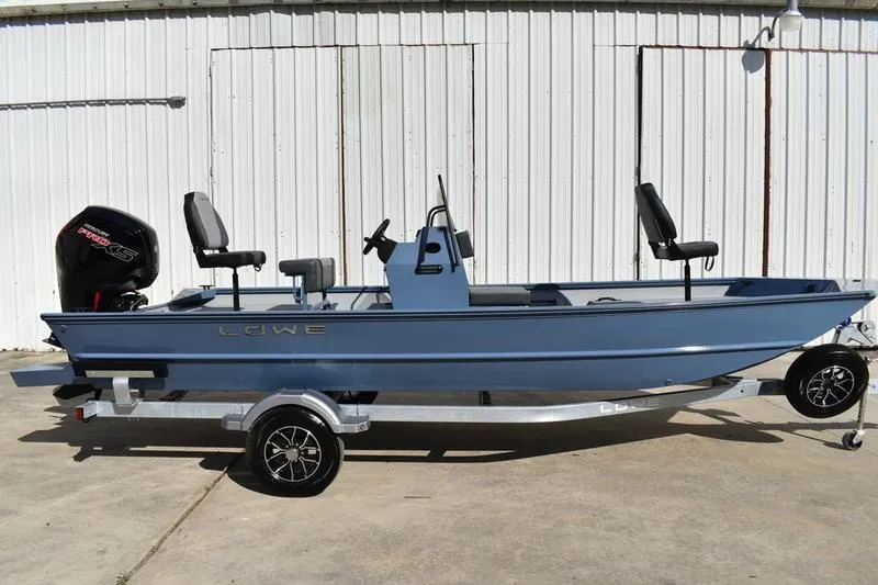 The Image of 2026 Lowe Roughneck RX2070 CC boat on trailer, parked outdoors. - 0