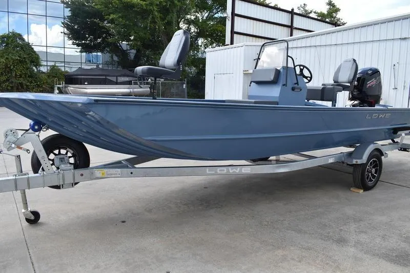 Slide: The Image of 2026 Lowe Roughneck RX2070 CC boat, close-up of metallic logo on blue hull. - 10