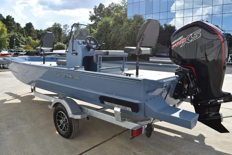 Slide: The Image of 2026 Lowe Roughneck RX2070 CC boat interior with central swivel seat and storage compartments. - 11