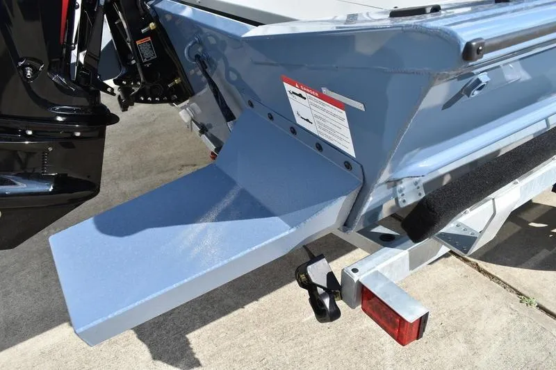 Slide: The Image of 2026 Lowe Roughneck RX2070 CC boat deck with storage compartments, blue and gray design. - 12