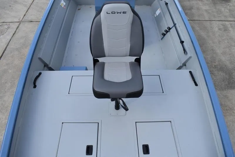 Slide: The Image of 2026 Lowe Roughneck RX2070 CC boat interior with storage compartments and safety instructions. - 17