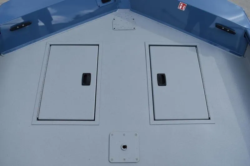 Slide: The Image of 2026 Lowe Roughneck RX2070 CC boat interior with handle and warning label. - 19