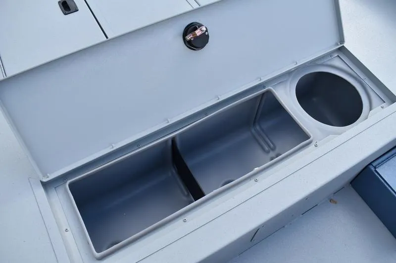 Slide: The Image of 2026 Lowe Roughneck RX2070 CC boat interior with steering console and seating. - 28