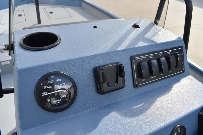 Slide: The Image of 2026 Lowe Roughneck RX2070 CC boat battery compartment with wiring and cable management. - 34