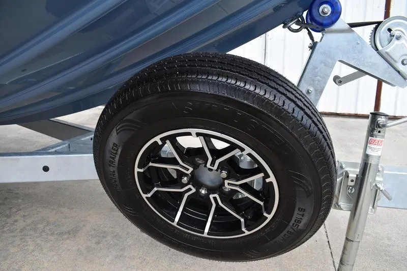 Slide: The Image of 2026 Lowe Roughneck RX2070 CC boat, rear view, heavy-duty edition, on concrete surface. - 5