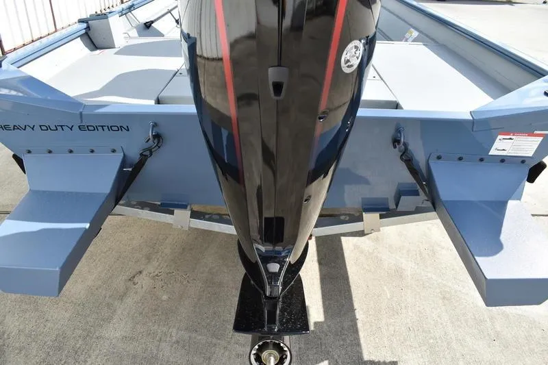 Slide: The Image of 2026 Lowe Roughneck RX2070 CC boat on trailer, showcasing hull design and trailer wheel. - 9