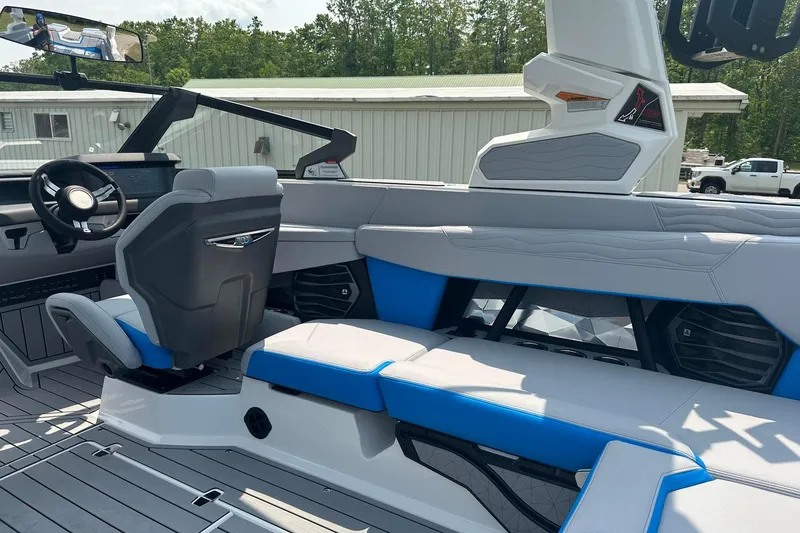 Slide: The Image of 2025 Nautique Super Air Nautique G23 interior with modern seating and steering wheel. - 12