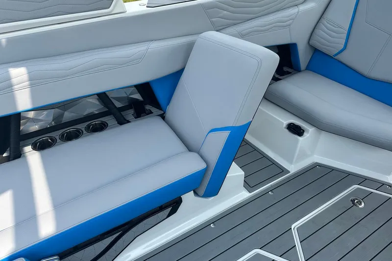 Slide: The Image of 2025 Nautique Super Air Nautique G23 interior seating with gray and blue upholstery. - 13