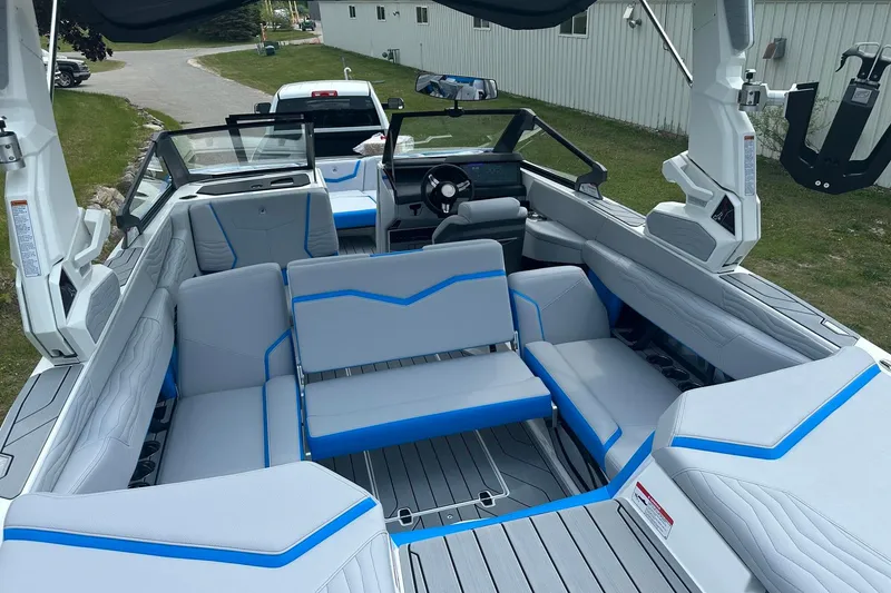 Slide: The Image of 2025 Nautique Super Air Nautique G23 interior with gray and blue seating, modern design. - 15