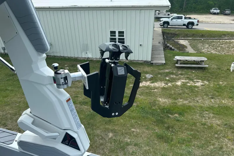 Slide: The Image of 2025 Nautique Super Air Nautique G23 boat tower with wakeboard rack, outdoor setting. - 16