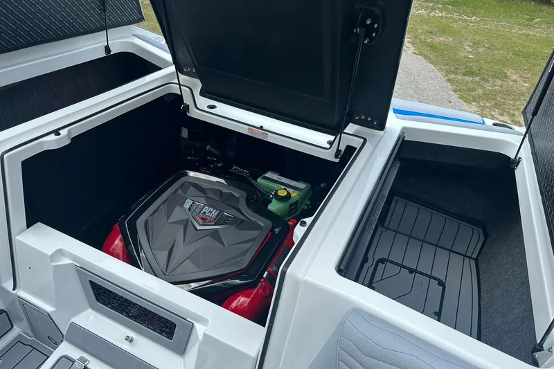 Slide: The Image of 2025 Nautique Super Air Nautique G23 engine compartment with PCM engine and storage area. - 18