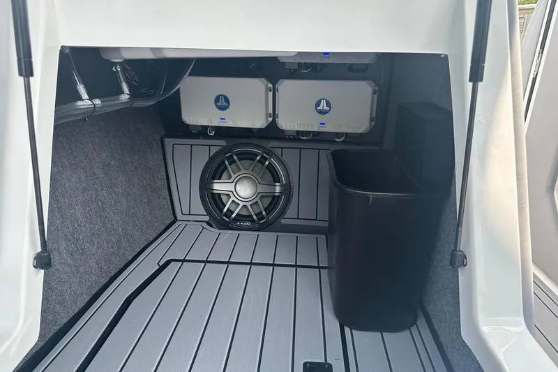 Slide: The Image of 2025 Nautique Super Air Nautique G23 interior with audio system and storage compartment. - 21